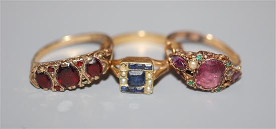 Three assorted gem set rings, 18ct, 15ct and 9ct, the 15ct ring in the suffragette colours(a.f.).
